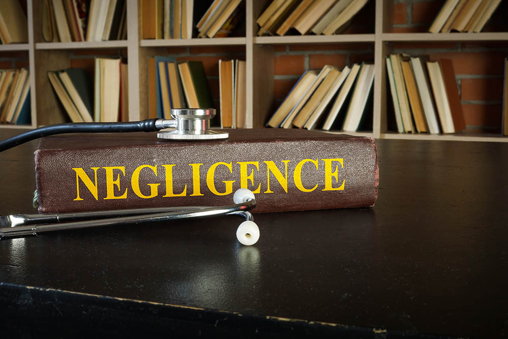 A stethoscope sitting on top of an negligence book.